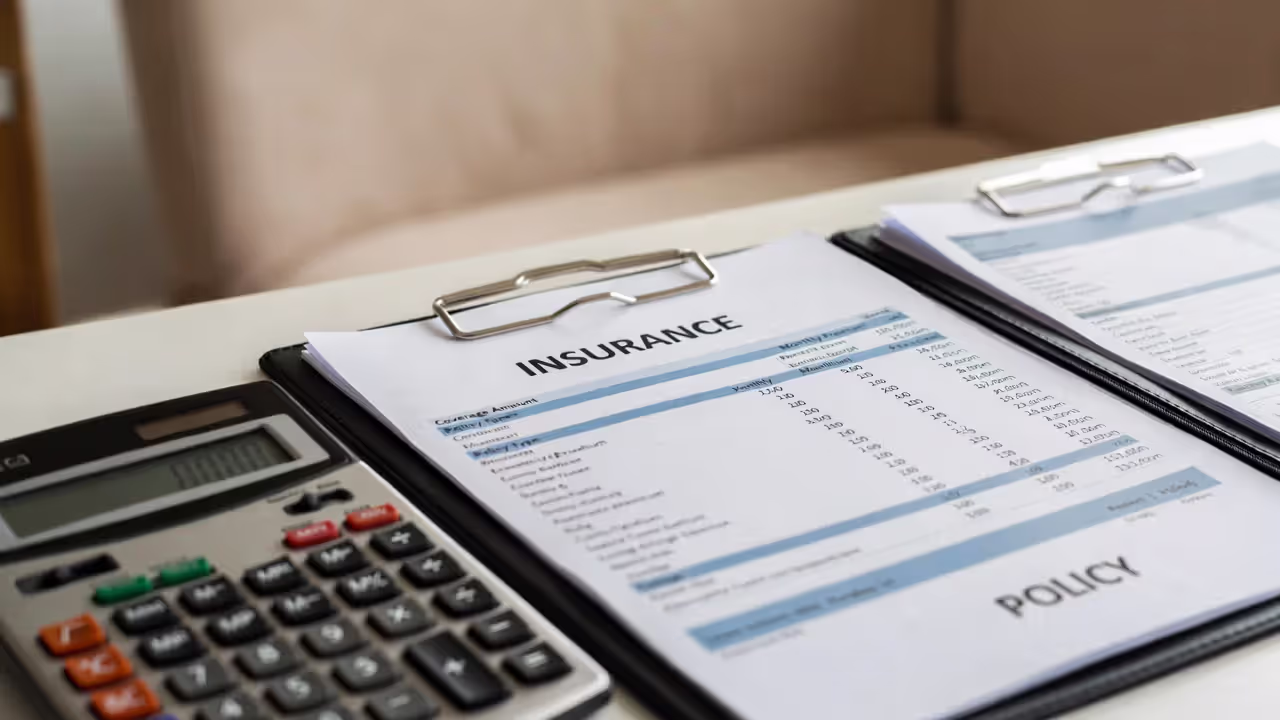 Overhead view of life insurance cost comparison table with calculator