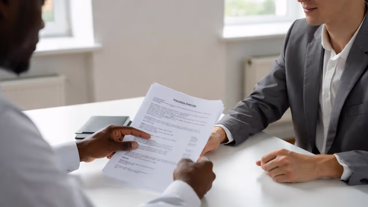 Two people reviewing life insurance policy documents together